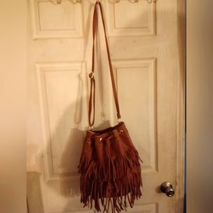 Faux leather bucket bag satchel with lots of fringe.